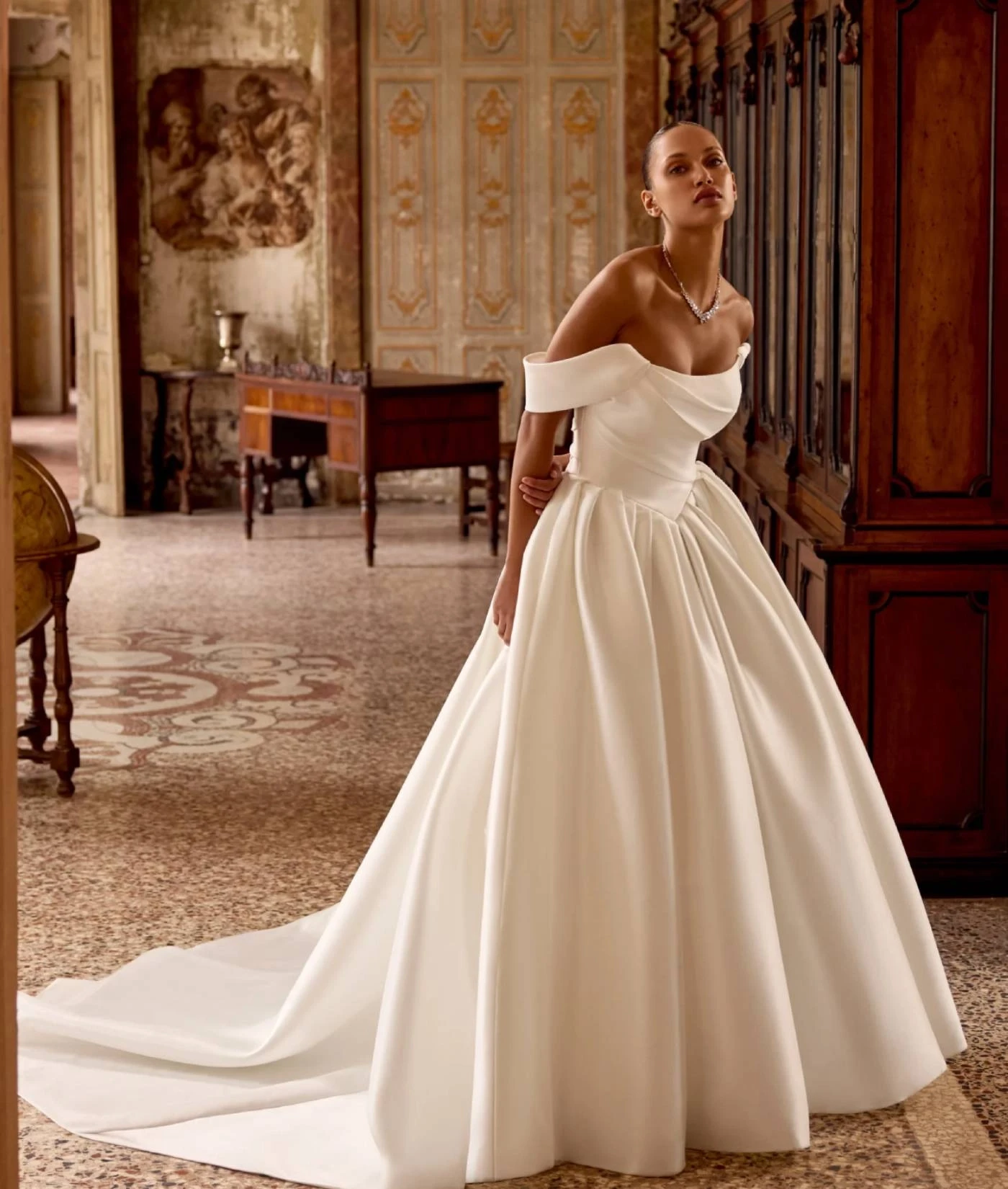 Model wearing white Justin Alexander 2025 dress