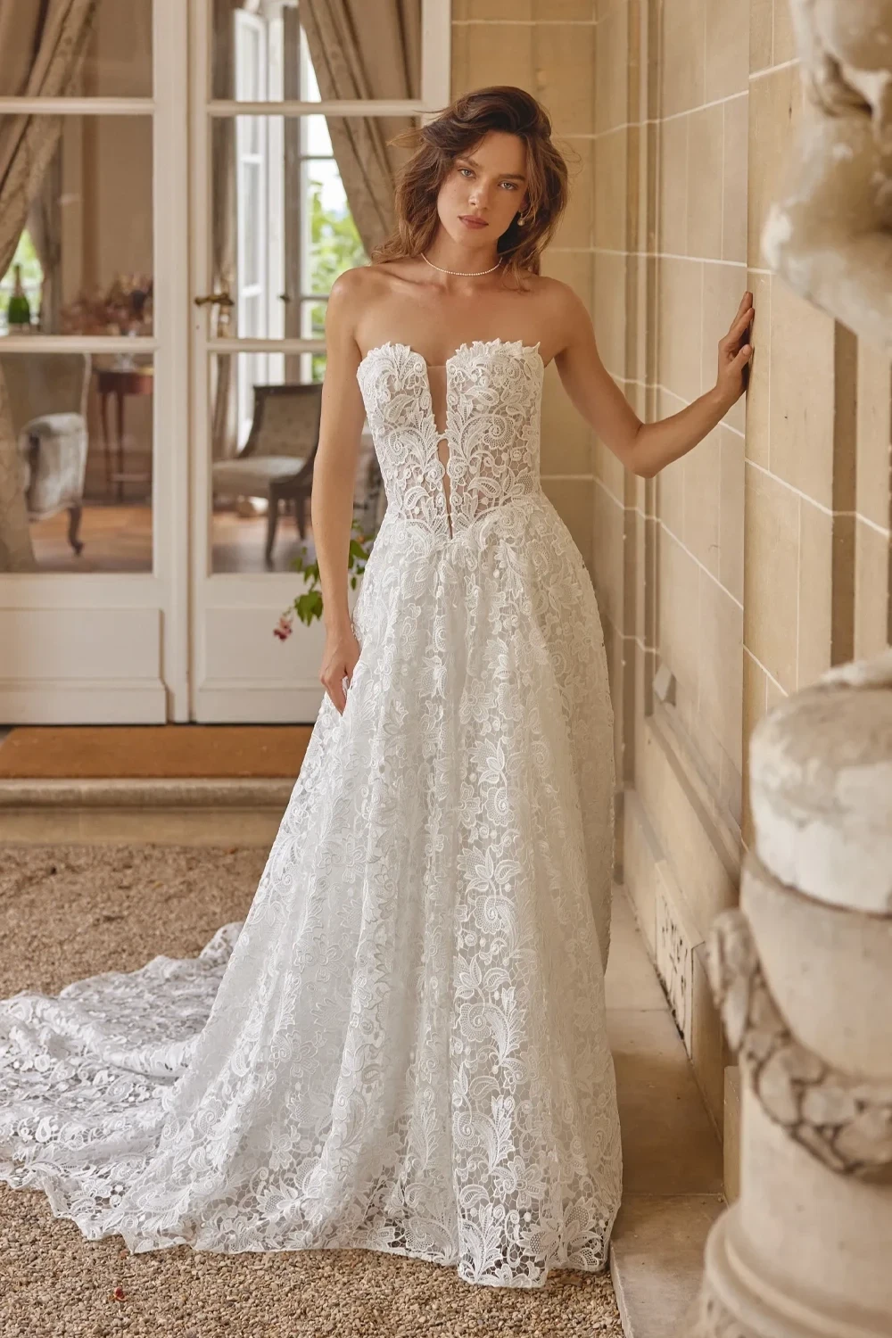 Model wearing white Justin Alexander 2025 dress