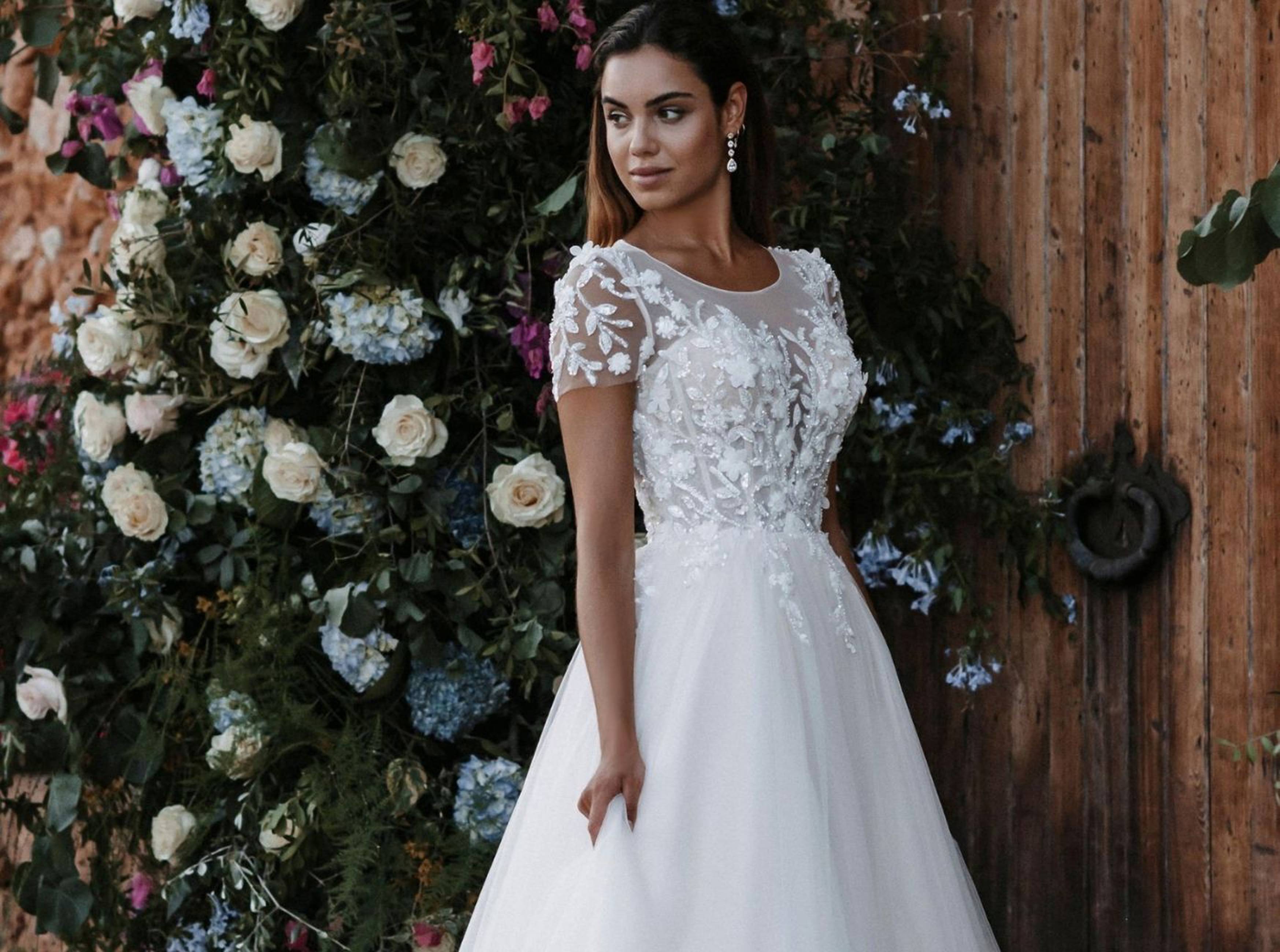 Model wearing white Disney Colection dress